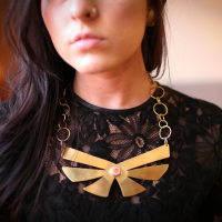 Handcrafted brass butterfly necklace with a high-grade Mexican fire opal stone in the center